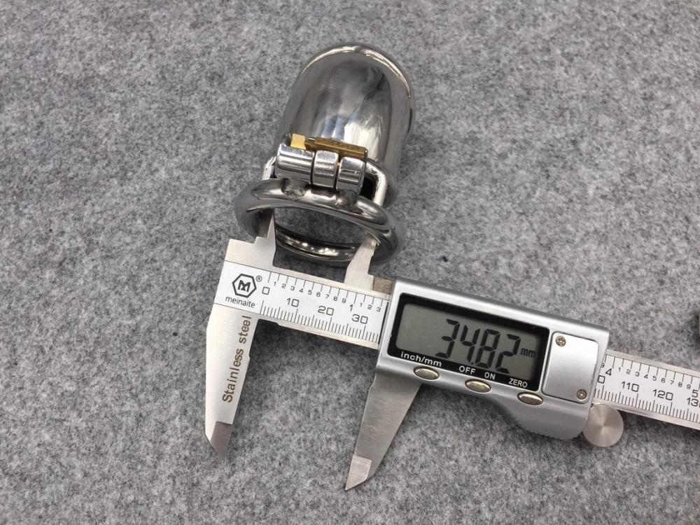 Digital caliper measuring the inner diameter of a metal chastity cage base ring